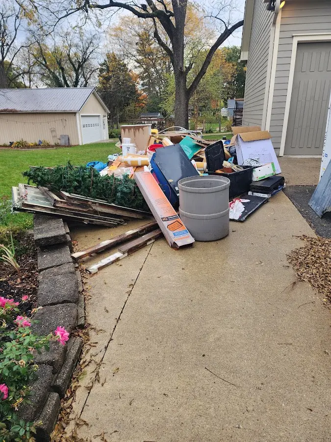 Dumpster being loaded with debris for Roofing Dumpster Rental in Lubbock